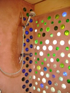 Shower room in earthship uses recycled glass bottles
